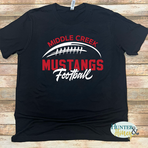 Black cotton short sleeve t-shirt with red and white Middle Creek Mustangs Football graphic.